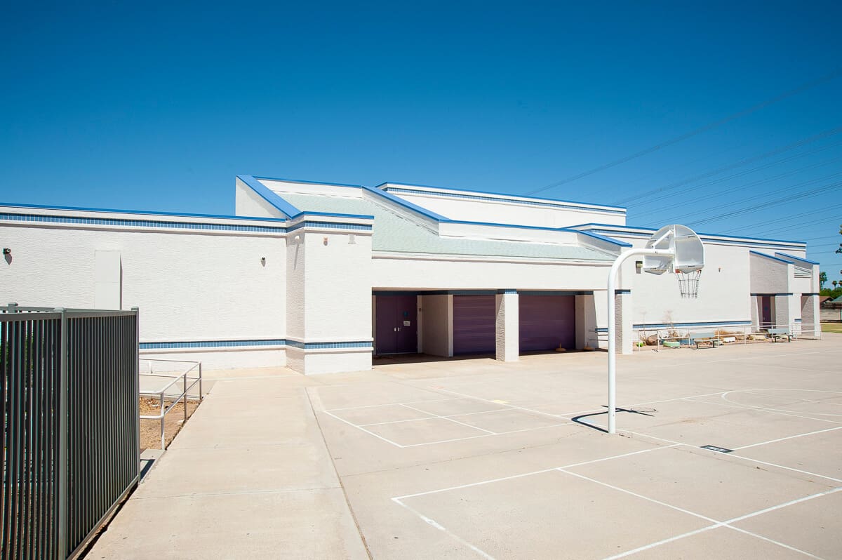 white building with basketball court