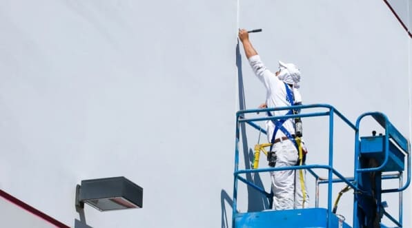 painter on a lifter doing his work