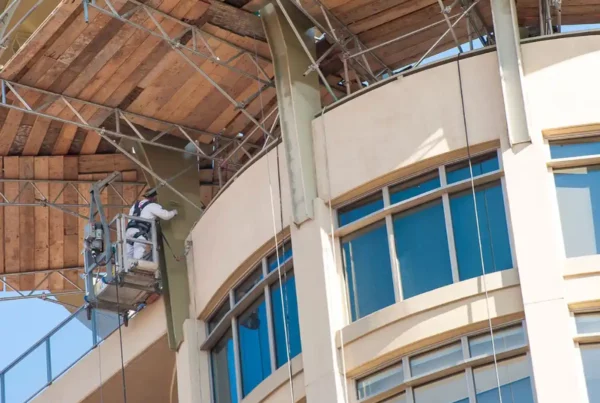 contractors working on painting the building