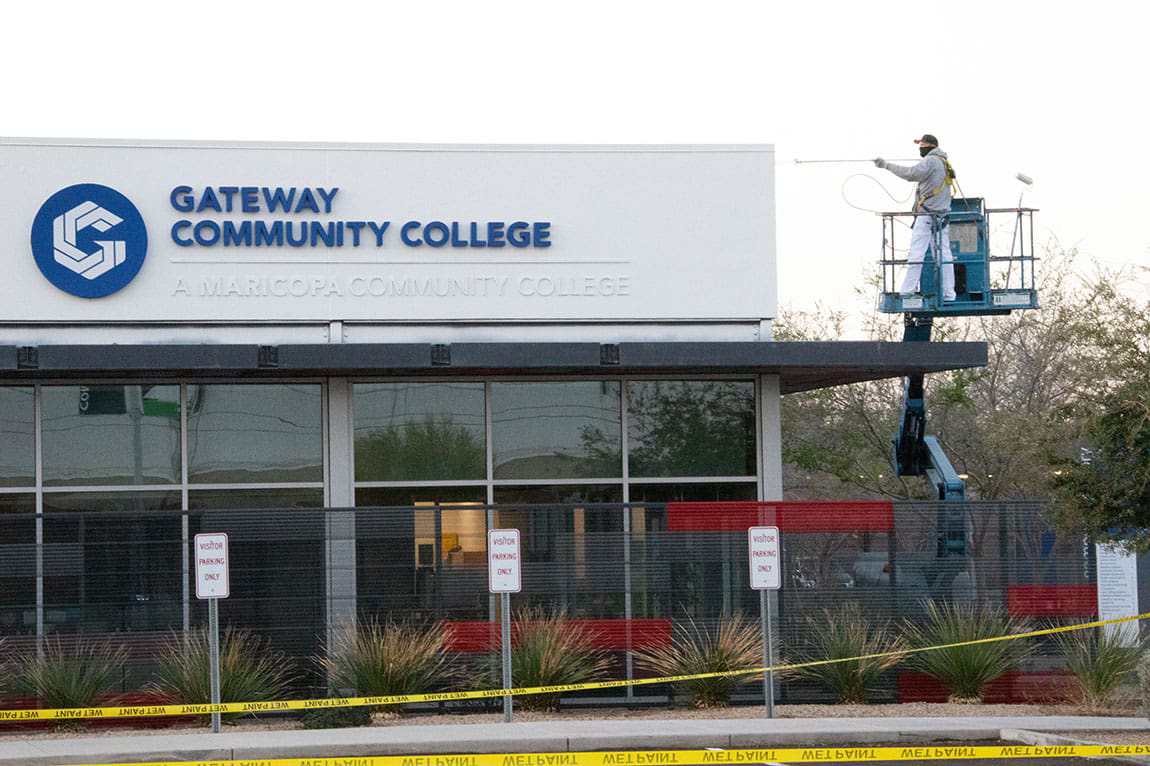 Man spray painting GCC building