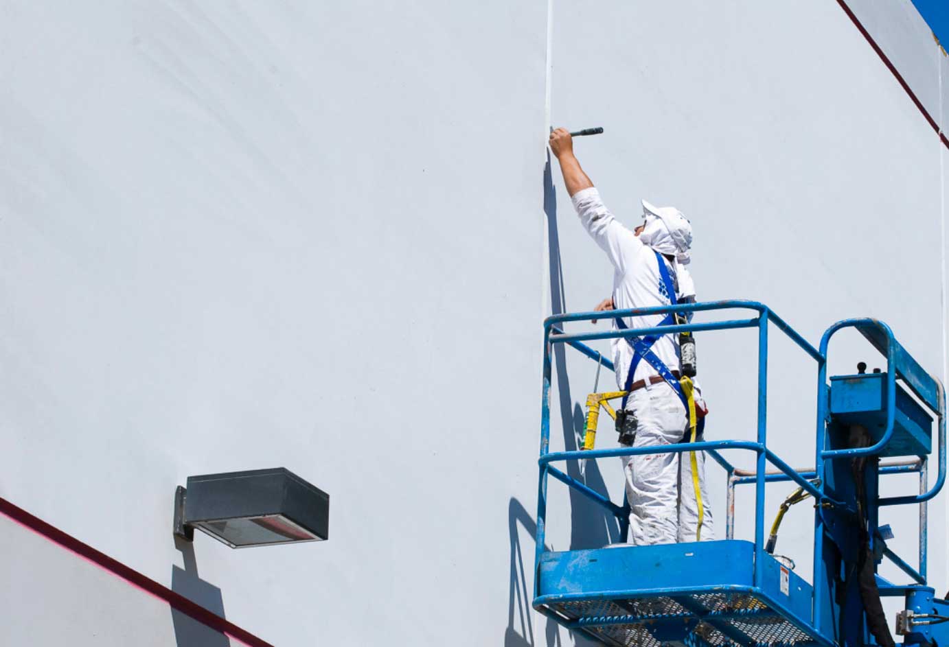 Professional painter working on a lift