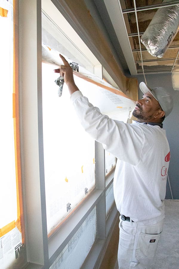 Painter covering the glass window