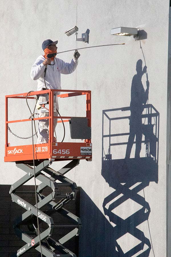 guy on a lifter spraying paint