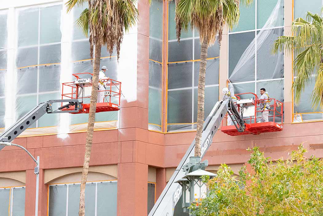 Two guys repainting the building