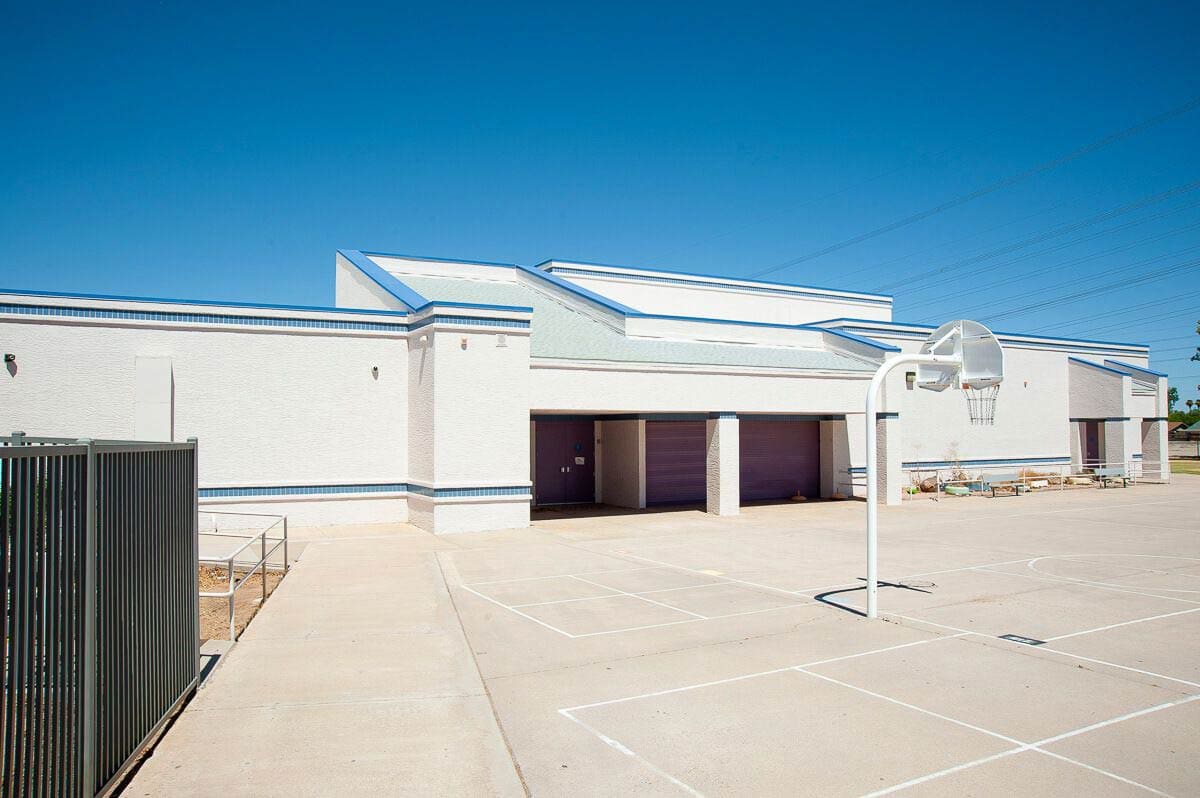 White building with basketball court