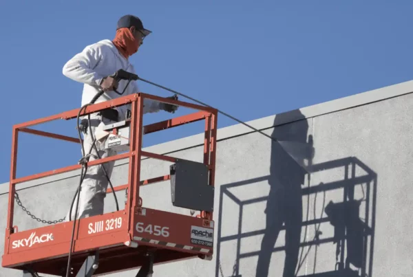 Guy holding a Commercial Paint Sprayer