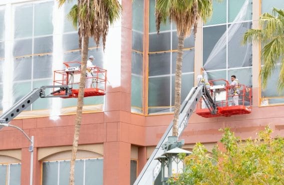 contractors painting the building using their equipment's