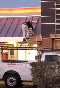 man climbing up the ladder